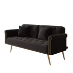 Canapé en velours noir orné de clous décoratifs et accompagné d'un coussin assorti.